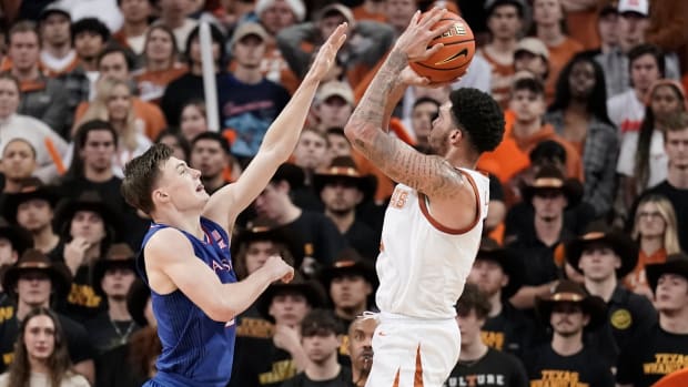 Feb 7, 2022; Austin, Texas, USA; Texas Longhorns forward Timmy Allen (0) shoots over Kansas Jayhawks guard Christian Braun (2) during the second half at Frank C. Erwin Jr. Center. Mandatory Credit: Scott Wachter-USA TODAY Sports